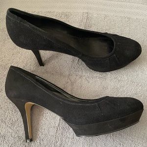 Black suede platform pumps.